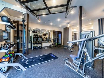 a gym with weights and other equipment on the floor and a glass ceiling at The Foundry, Indiana